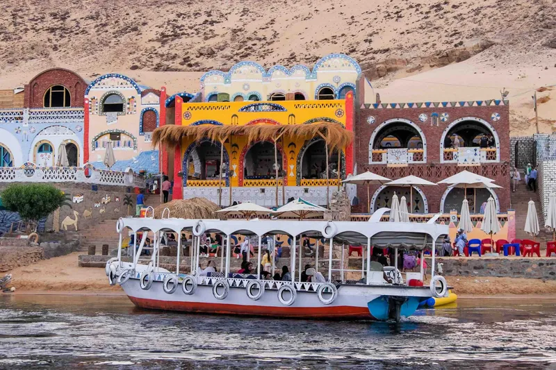 A motor boat arriving into the dock at the Nubian Village in Aswan